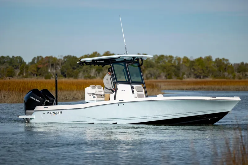 Yacht Photos Pics 2024 Caymas 281 HB boat cruising on a calm lake with a scenic background.