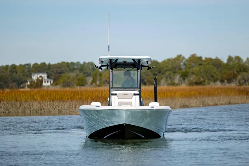 Yacht Photos Pics 2024 Caymas 281 HB boat cruising on a calm river.