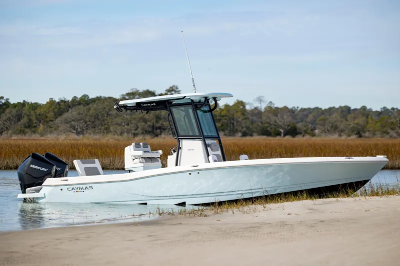  Yacht Photos Pics 2024 Caymas 281 HB boat docked on a serene shoreline.