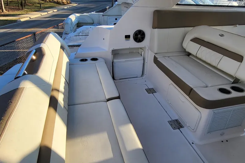  Yacht Photos Pics 2018 Regal 35 Sport Coupe interior with beige seating and cup holders.