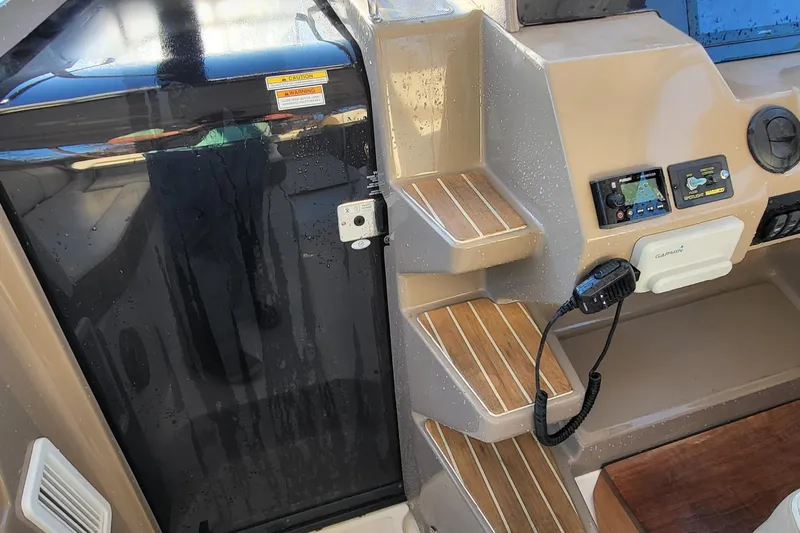 Yacht Photos Pics 2018 Regal 35 Sport Coupe cockpit with steps, control panel, and Garmin device.