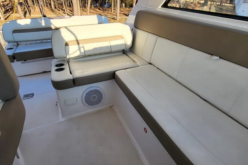  Yacht Photos Pics Luxurious seating area on 2018 Regal 35 Sport Coupe boat, featuring beige upholstery.