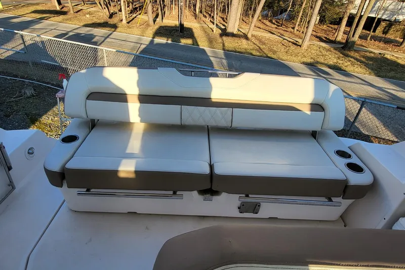  Yacht Photos Pics 2018 Regal 35 Sport Coupe boat seating with cup holders, in a sunny outdoor setting.