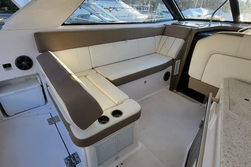  Yacht Photos Pics 2018 Regal 35 Sport Coupe interior with beige seating and cup holders.