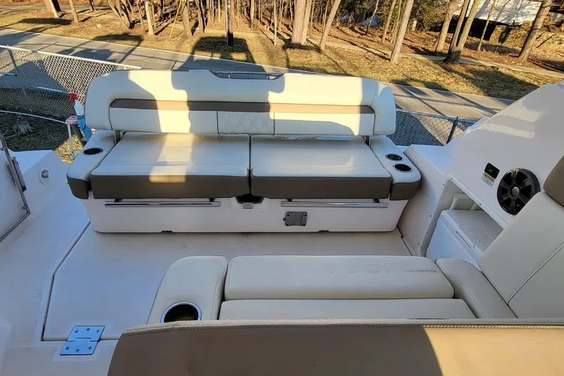  Yacht Photos Pics 2018 Regal 35 Sport Coupe boat interior with beige seating and cup holders.