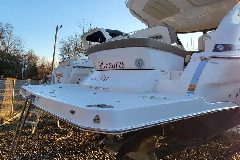  Yacht Photos Pics 2018 Regal 35 Sport Coupe boat with "Pleasures at Sea" text on the stern.
