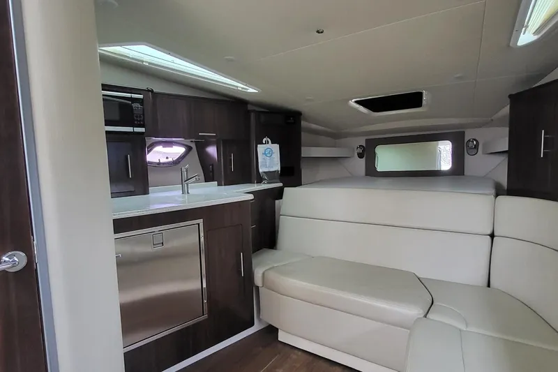  Yacht Photos Pics Luxurious interior of 2018 Regal 35 Sport Coupe with kitchenette and seating area.