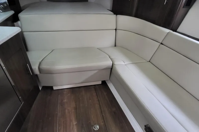  Yacht Photos Pics 2018 Regal 35 Sport Coupe interior with beige leather seating and wooden flooring.