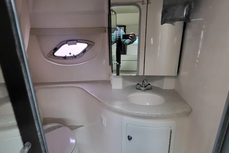  Yacht Photos Pics 2018 Regal 35 Sport Coupe bathroom with sink, mirror, and porthole window.