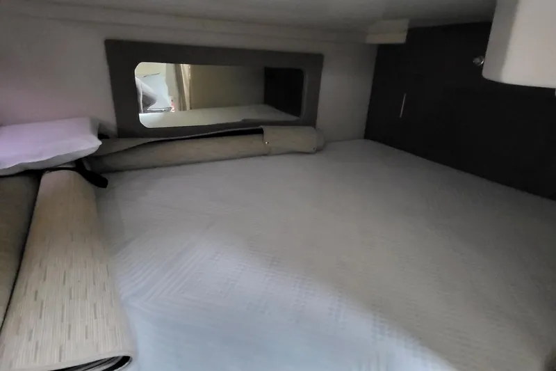  Yacht Photos Pics 2018 Regal 35 Sport Coupe cabin interior with bed and mirror.