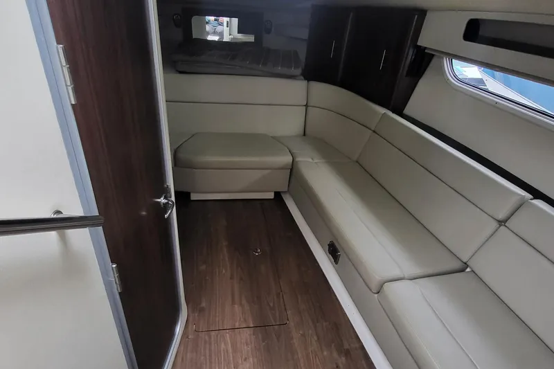  Yacht Photos Pics 2018 Regal 35 Sport Coupe interior with beige seating and wood flooring.