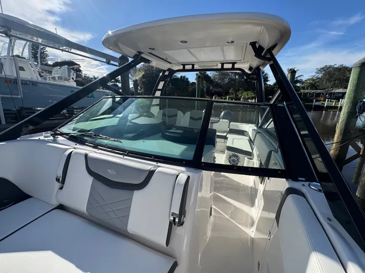  Yacht Photos Pics 2023 Chaparral 280 OSX boat with sleek design docked at marina.