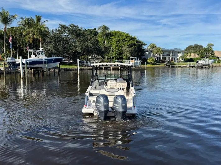  Yacht Photos Pics 2023 Chaparral 280 OSX boat on calm water near dock.