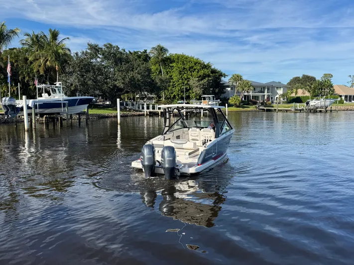  Yacht Photos Pics 2023 Chaparral 280 OSX on calm water near dock.