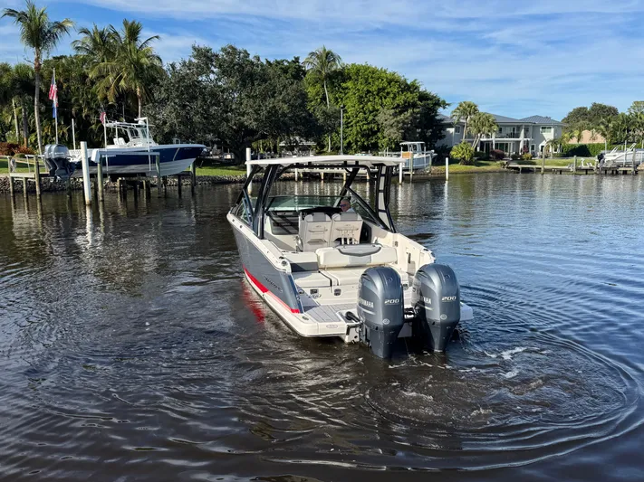  Yacht Photos Pics 2023 Chaparral 280 OSX boat on calm water.