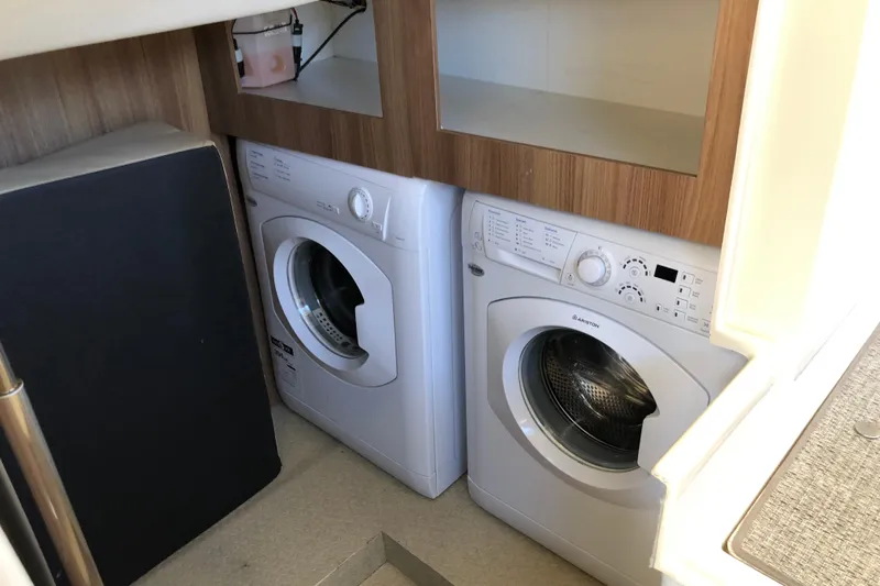  Yacht Photos Pics Laundry area with washer and dryer inside 2024 Ranger Tugs R-43 CB boat.