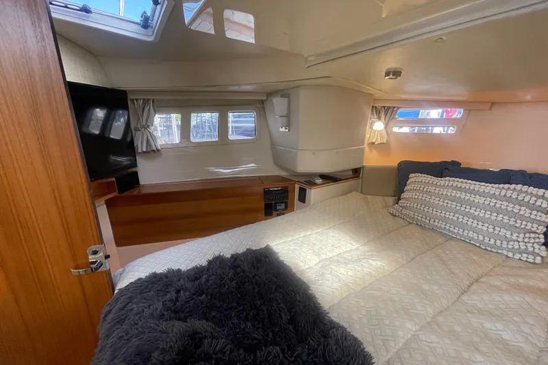  Yacht Photos Pics 2024 Ranger Tugs R-43 CB cabin interior with cozy bed and natural light.