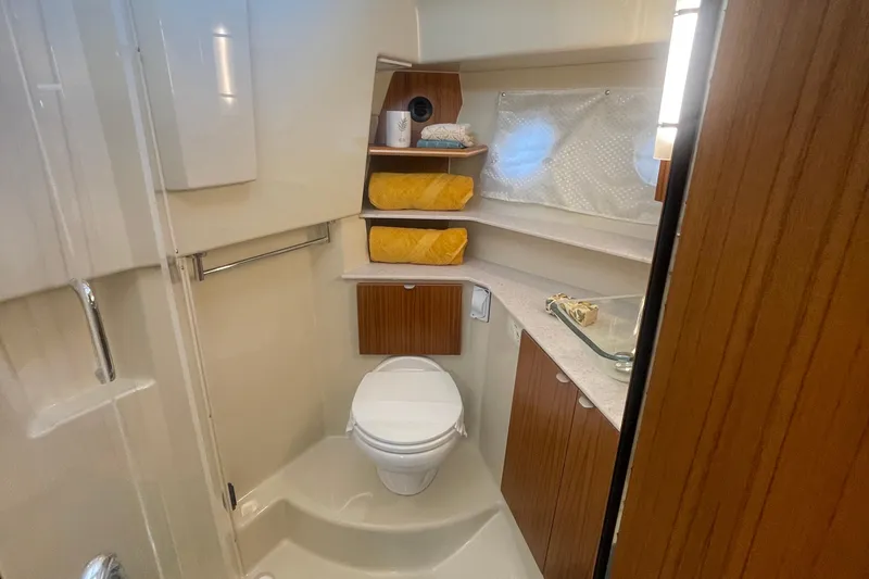  Yacht Photos Pics 2024 Ranger Tugs R-43 CB bathroom with modern fixtures and wooden cabinetry.