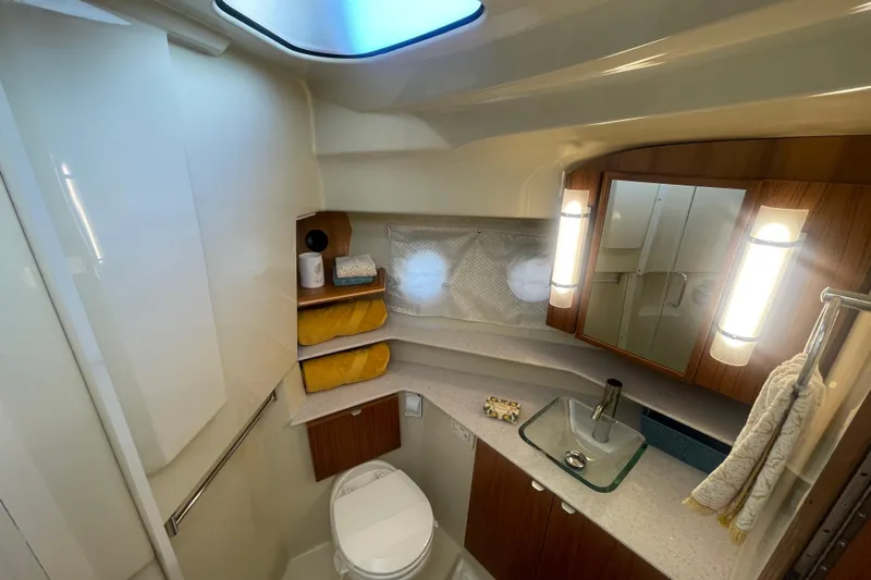  Yacht Photos Pics 2024 Ranger Tugs R-43 CB bathroom with modern fixtures and elegant wood accents.