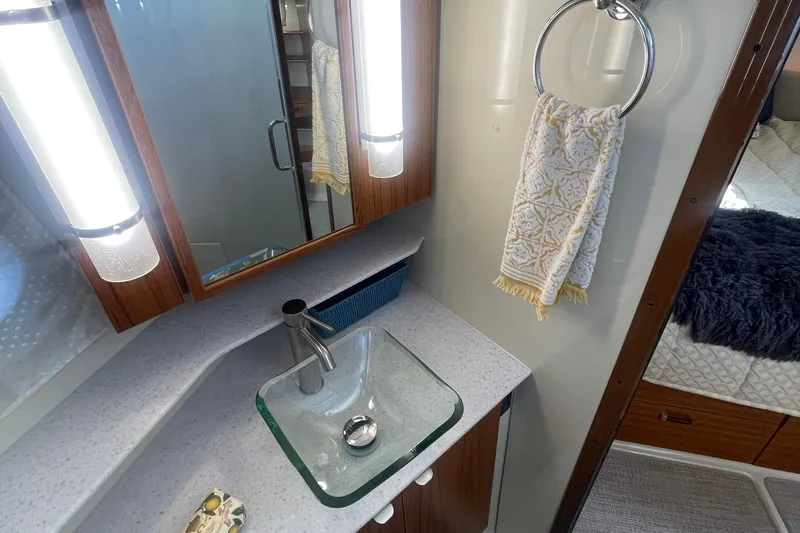  Yacht Photos Pics 2024 Ranger Tugs R-43 CB bathroom with modern sink, mirror, and towel holder.