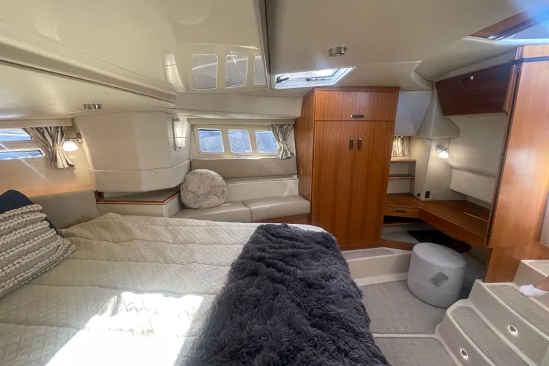  Yacht Photos Pics Luxurious interior of 2024 Ranger Tugs R-43 CB with cozy bed and elegant wood finishes.