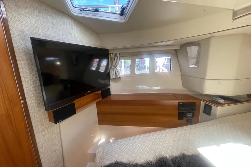  Yacht Photos Pics 2024 Ranger Tugs R-43 CB interior cabin with TV and modern furnishings.