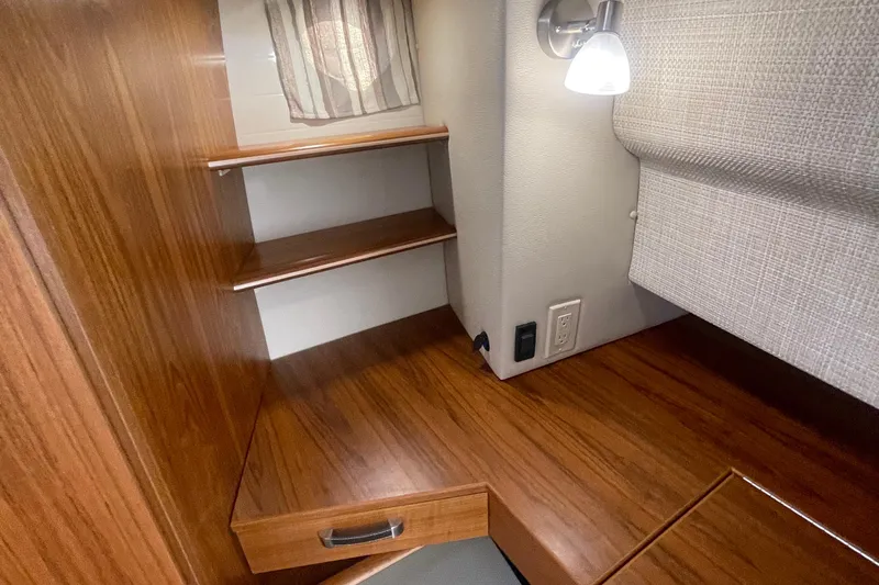  Yacht Photos Pics 2024 Ranger Tugs R-43 CB interior with wooden shelves and modern lighting.