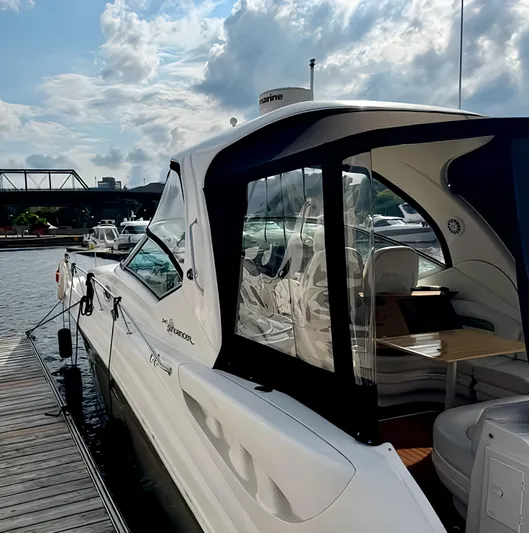  Yacht Photos Pics 2006 Sea Ray 340 Sundancer docked under a partly cloudy sky.