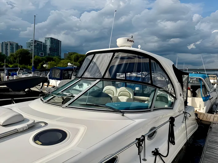  Yacht Photos Pics 2006 Sea Ray 340 Sundancer docked at marina under cloudy sky.