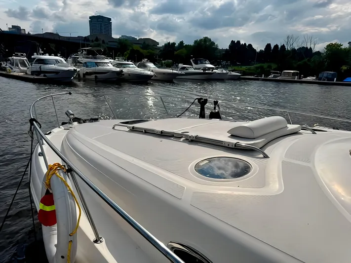  Yacht Photos Pics 2006 Sea Ray 340 Sundancer docked in a marina with other boats.