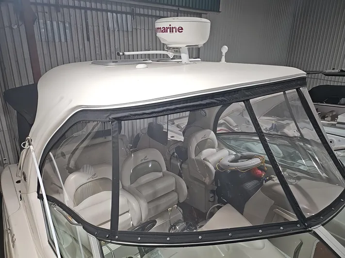  Yacht Photos Pics 2006 Sea Ray 340 Sundancer boat with enclosed cockpit and radar, docked indoors.