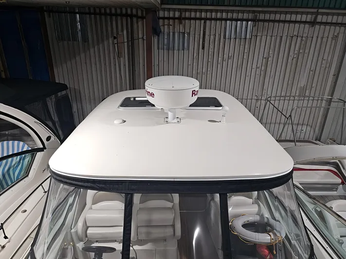  Yacht Photos Pics 2006 Sea Ray 340 Sundancer boat with radar dome, docked in a covered marina.