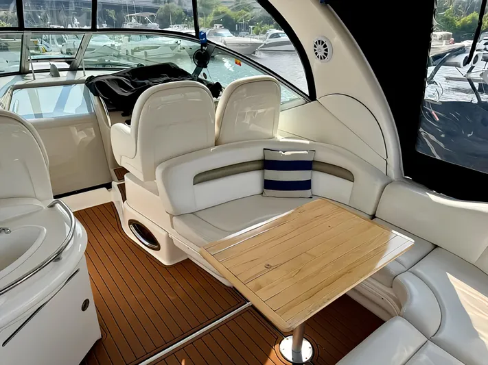  Yacht Photos Pics 2006 Sea Ray 340 Sundancer interior with white seating, wooden table, and nautical decor.