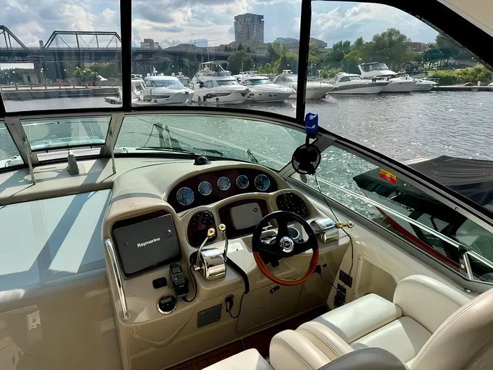  Yacht Photos Pics Interior view of 2006 Sea Ray 340 Sundancer yacht cockpit with marina background.