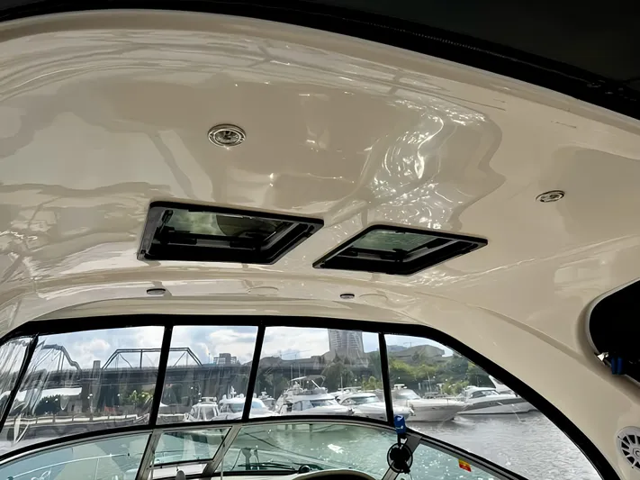  Yacht Photos Pics Interior view of 2006 Sea Ray 340 Sundancer boat with sunroof and marina background.