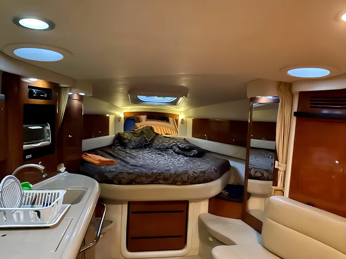  Yacht Photos Pics Luxurious interior of 2006 Sea Ray 340 Sundancer yacht with cozy bed and kitchenette.