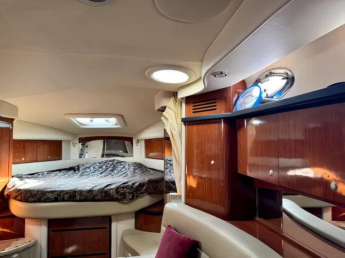  Yacht Photos Pics Luxurious 2006 Sea Ray 340 Sundancer cabin interior with wood finish and cozy sleeping area.
