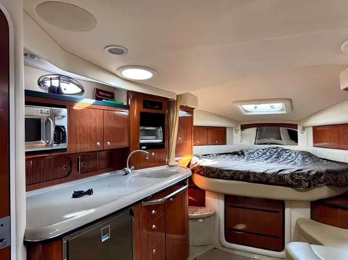  Yacht Photos Pics 2006 Sea Ray 340 Sundancer interior with kitchenette and cozy sleeping area.