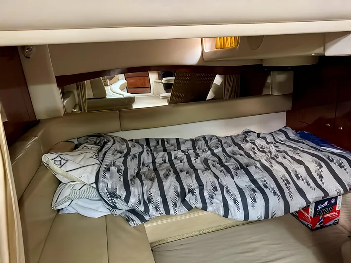  Yacht Photos Pics 2006 Sea Ray 340 Sundancer cabin with bed, striped bedding, and cozy interior.