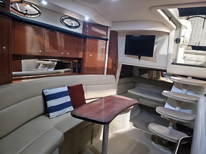  Yacht Photos Pics Luxurious 2006 Sea Ray 340 Sundancer cabin with plush seating, wooden table, and modern amenities.