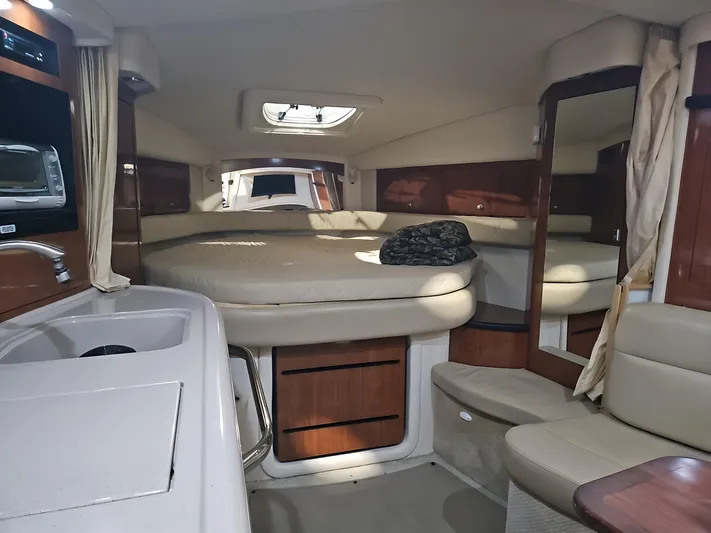  Yacht Photos Pics 2006 Sea Ray 340 Sundancer cabin interior with bed, seating, and storage.