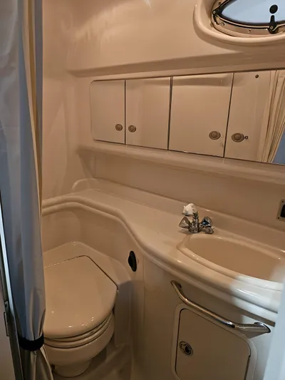  Yacht Photos Pics 2006 Sea Ray 340 Sundancer bathroom with sink, toilet, and storage cabinets.