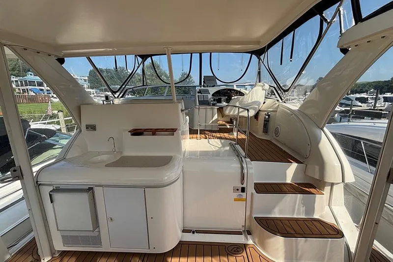  Yacht Photos Pics 2003 Cruisers Yachts 3750 Motoryacht interior with helm, sink, and seating area.