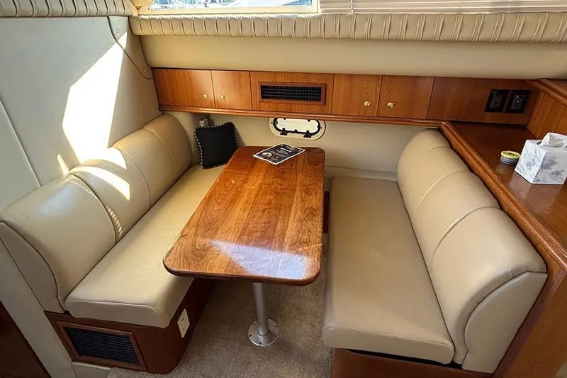  Yacht Photos Pics 2003 Cruisers Yachts 3750 Motoryacht interior with beige seating and wooden table.