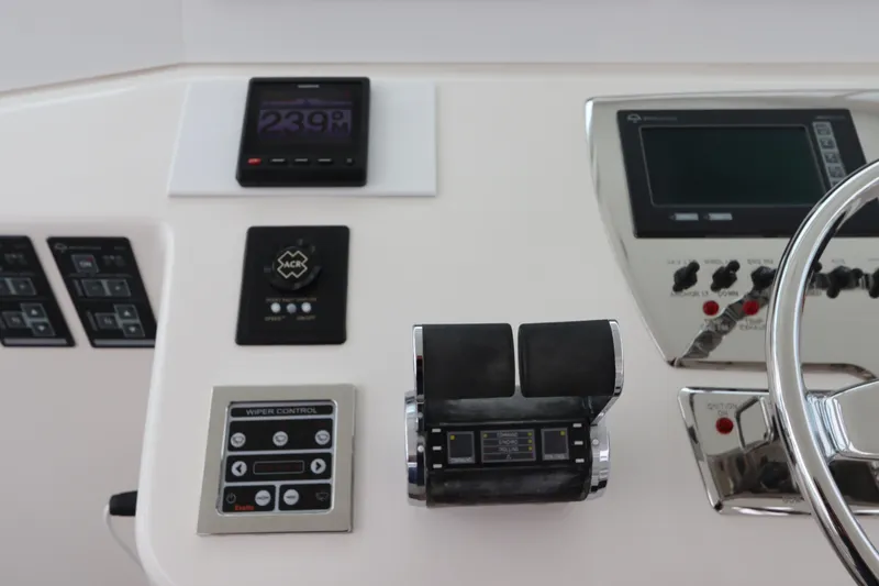  Yacht Photos Pics Control panel of a 2007 Cabo 40 Hardtop Express boat with various instruments and steering wheel.