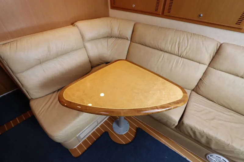  Yacht Photos Pics Luxurious beige leather seating with a wooden table in a 2007 Cabo 40 Hardtop Express.