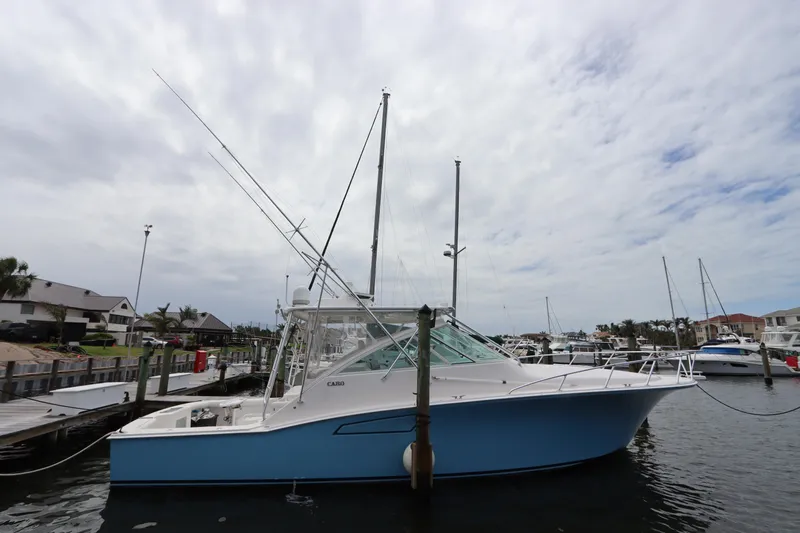  Yacht Photos Pics 2007 Cabo 40 Hardtop Express boat docked at marina under cloudy sky.
