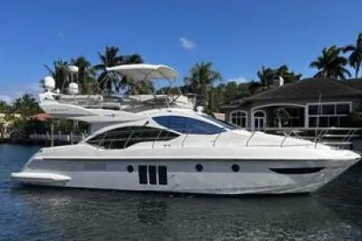  Yacht Photos Pics 2014 Azimut Fly yacht on water, surrounded by palm trees and houses.