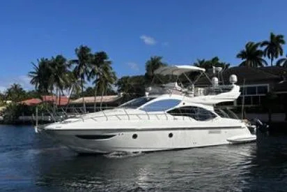  Yacht Photos Pics 2014 Azimut Fly yacht cruising near palm trees under a clear blue sky.