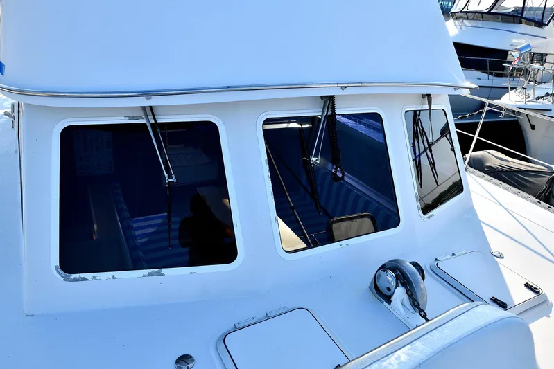 Two Buoys Yacht Photos Pics 2002 PDQ 32 Power Catamaran with white exterior and large windows at a marina.